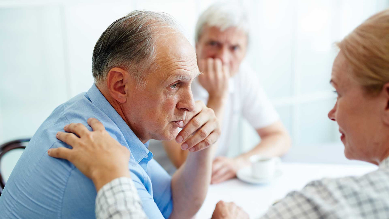 Older man in support meeting